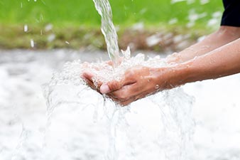 Catching a stream of water in your hands