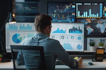 Fund manager working with an array of screens showing share values from around the world