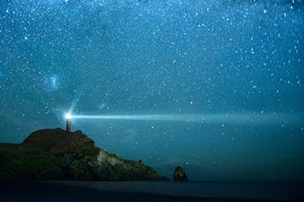 Lighthouse against a starry sky
