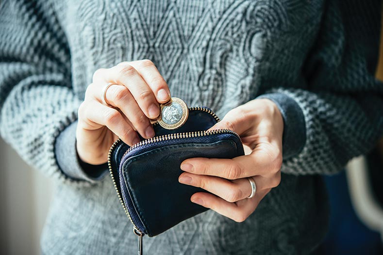 Woman taking a coin from her purse