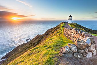 Looking across Cape Reinga lighthouse towards the sunset