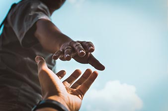 One person giving another person a hand