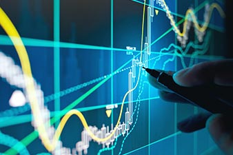 Person tracking share prices on a screen